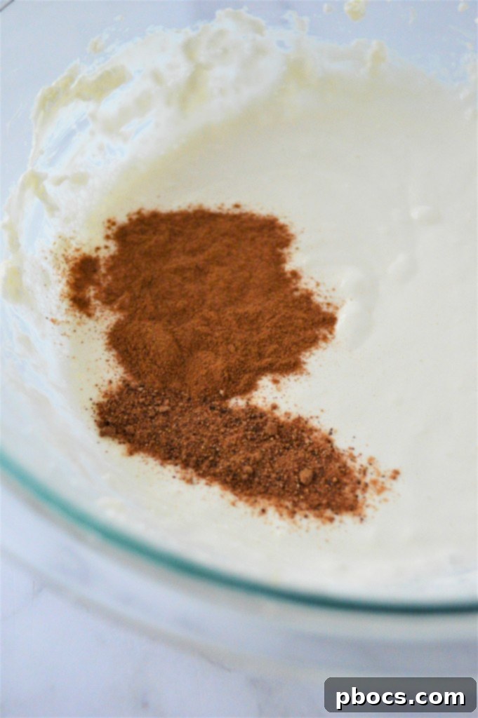 Keto Eggnog Cheesecake Bars 12 Adding Eggnog and Spices to Cheesecake Mixture