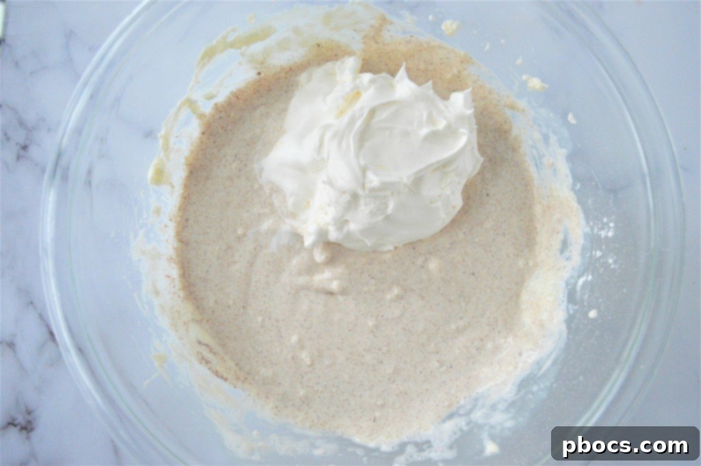 Keto Eggnog Cheesecake Bars 13 Pouring Eggnog Cheesecake Filling Over Crust