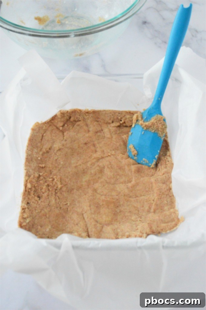 Keto Eggnog Cheesecake Bars 10 Pressing the Almond Flour Crust for Eggnog Cheesecake Bars