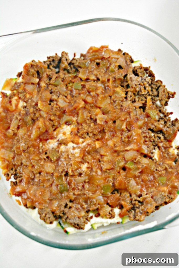 Ricotta layer spread over zucchini.