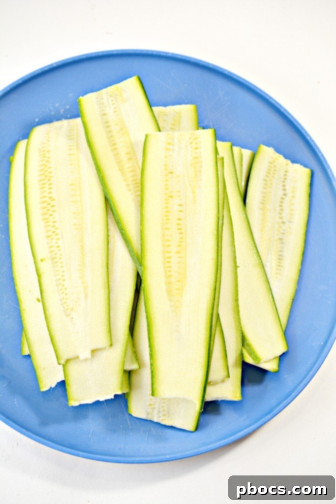 Thinly sliced zucchini strips, ready to be used as low-carb lasagna noodles.