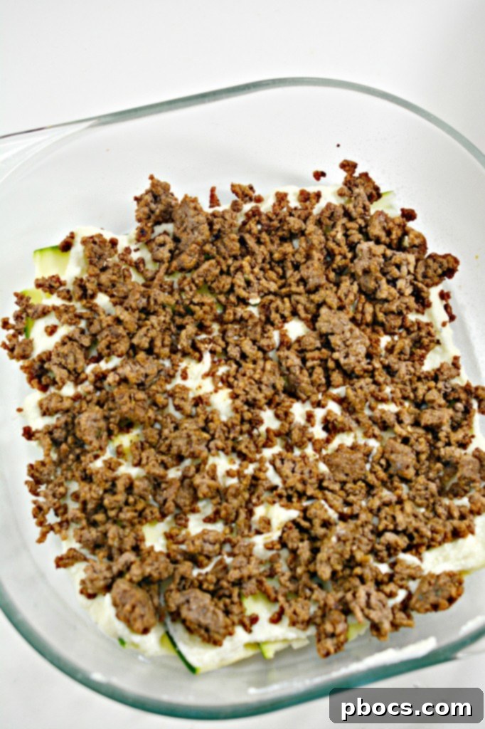 Ground beef browning in a skillet.