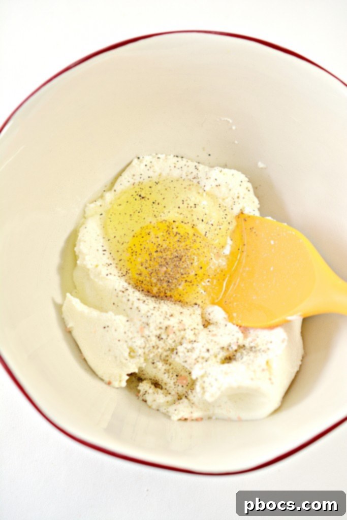 First layer of zucchini in a baking dish.