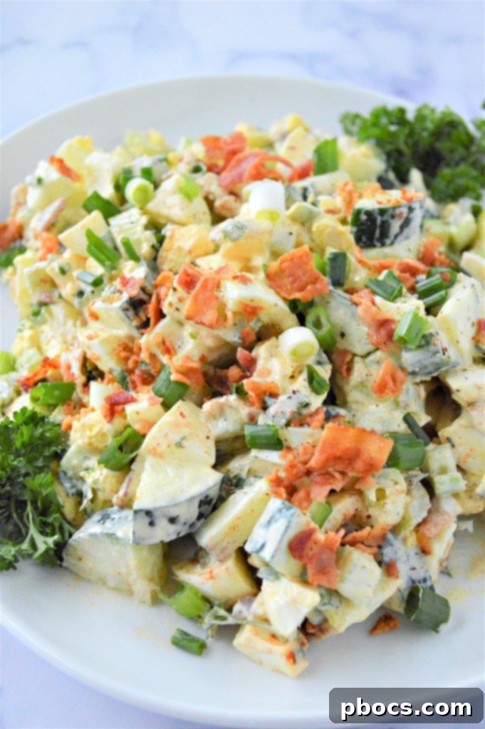 Delicious Low Carb Cucumber Egg Salad Recipe served in a bowl, garnished with fresh parsley.