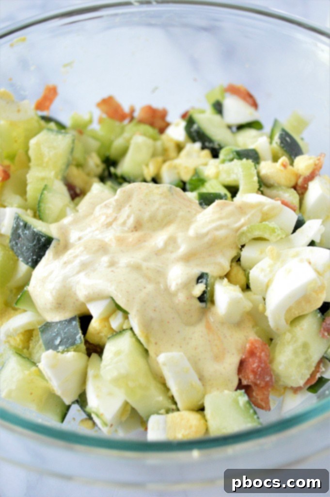 Step 4: Pouring the dressing over the chopped ingredients and stirring.