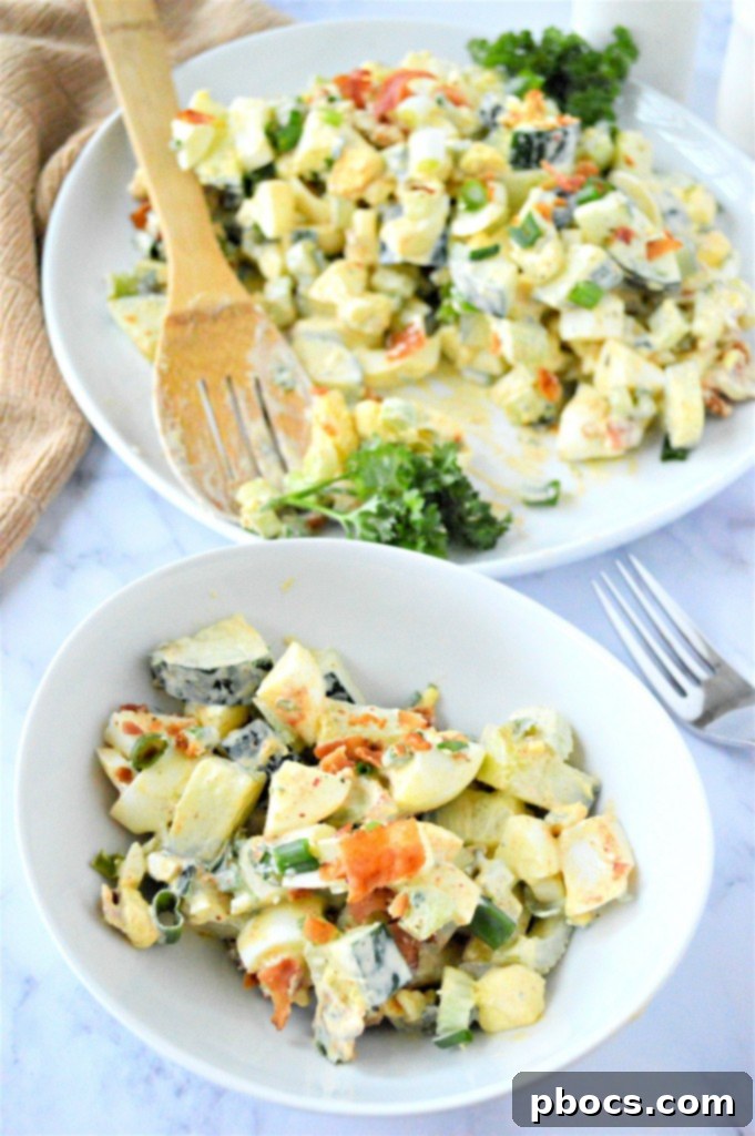 A bowl of Low Carb Cucumber Egg Salad garnished with fresh herbs and bacon.