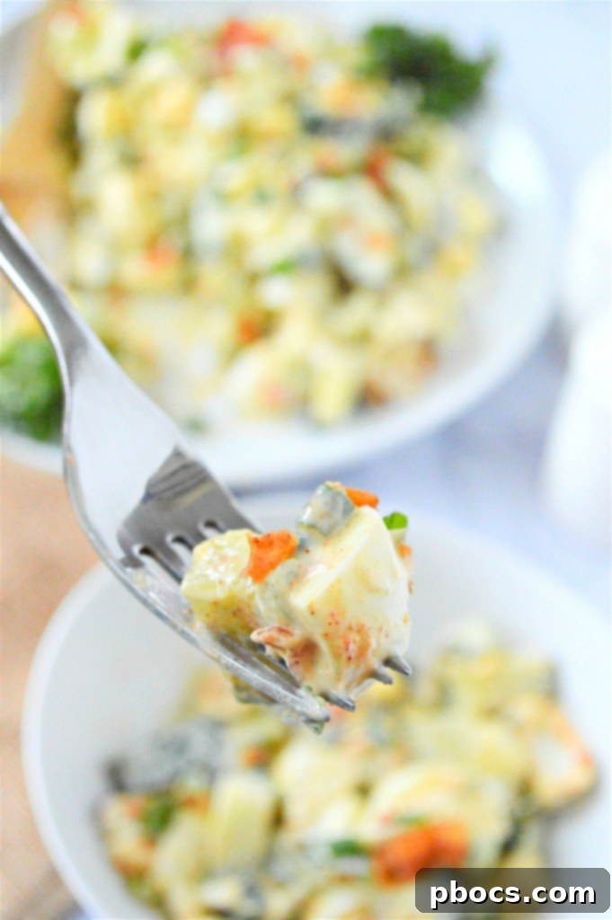 Plated Low Carb Cucumber Egg Salad with fresh herbs and a side of lettuce.