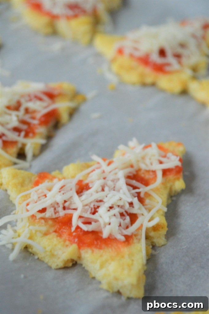 Step 6: Topping mini pizzas with sauce, cheese, and pepperoni