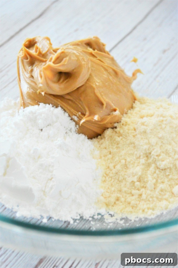 Effortless Keto Chocolate Peanut Butter Bars 8 Step 1: Mixing peanut butter, powdered sugar substitute, and coconut flour for the base layer.