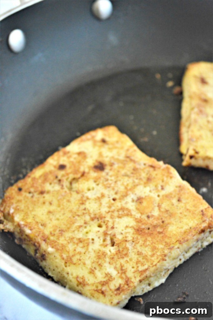 Cooking Eggnog Keto French Toast in a skillet