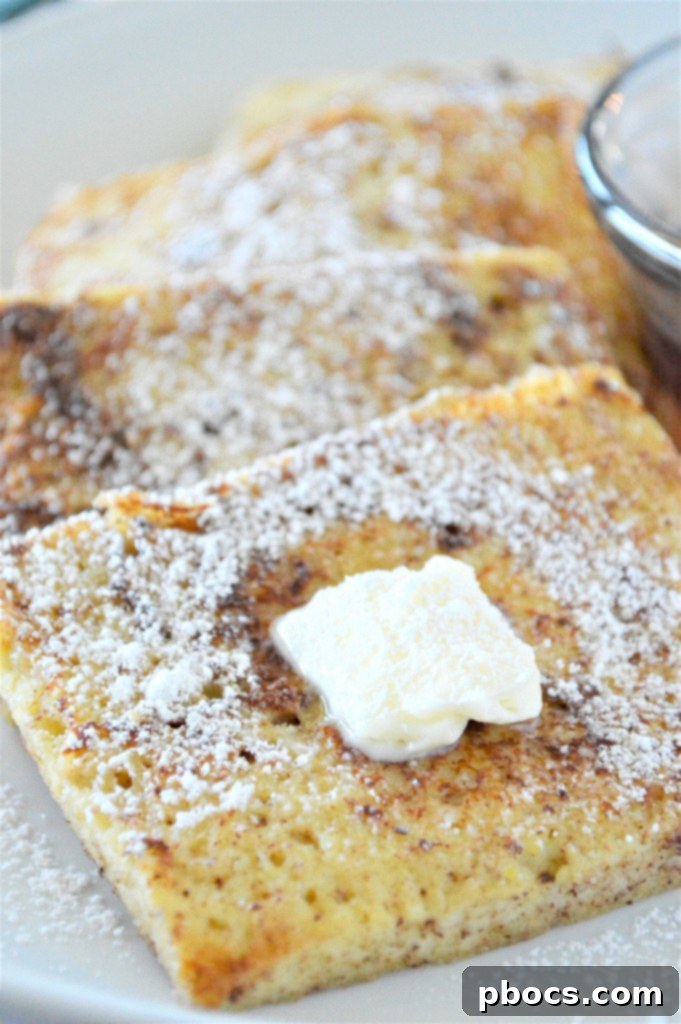 A stack of Eggnog Keto French Toast with a pat of butter