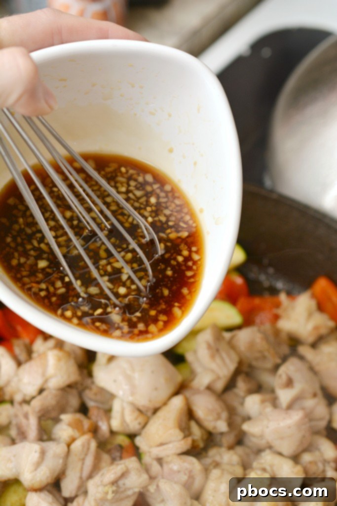 Whisking together the Kung Pao sauce ingredients in a bowl.