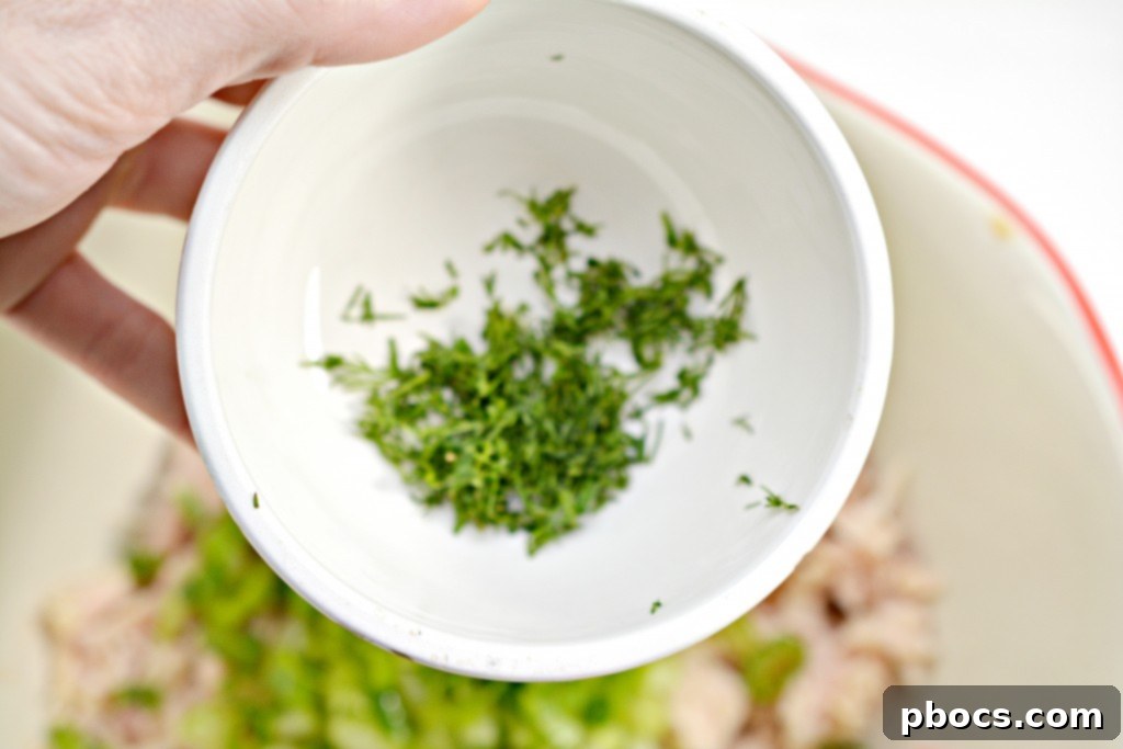 Combining chicken, vegetables, and sauce in a skillet.