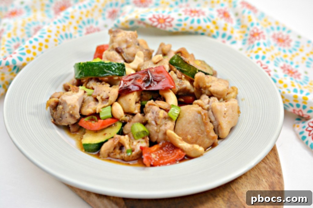 Serving of Keto Kung Pao Chicken garnished with green onions and cashews.