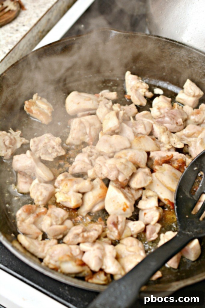 Heating oil in a large skillet for Keto Kung Pao Chicken.