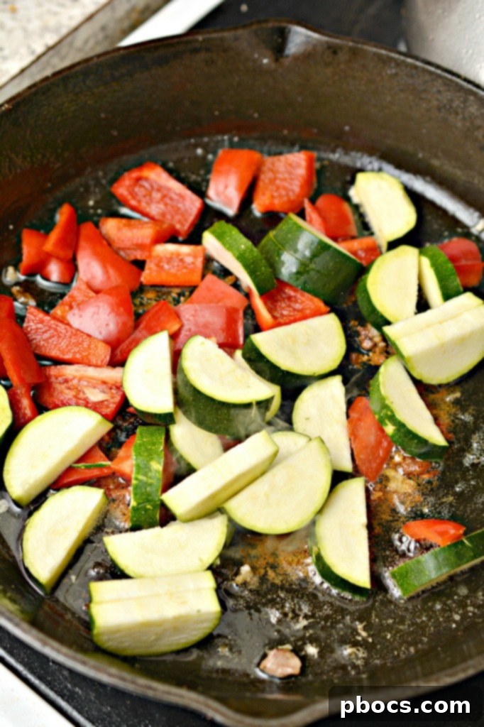Sautéing chicken pieces in a skillet for Kung Pao.
