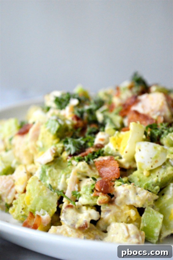 Overhead view of Low Carb Chicken Egg Salad in a glass bowl, ready for serving
