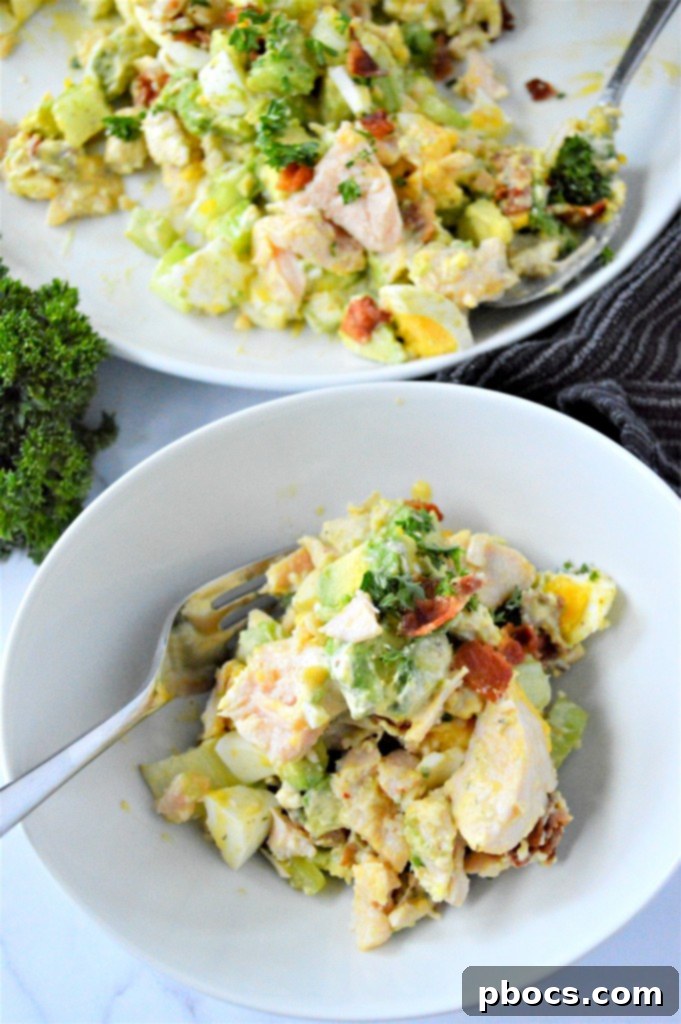 A serving of Low Carb Chicken Egg Salad in a bowl, garnished with fresh parsley