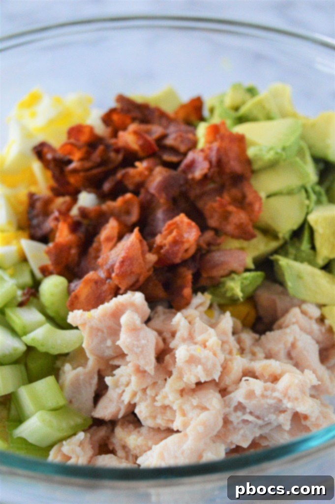 Step 1: Combining chicken, avocado, eggs, bacon, and celery in a large bowl