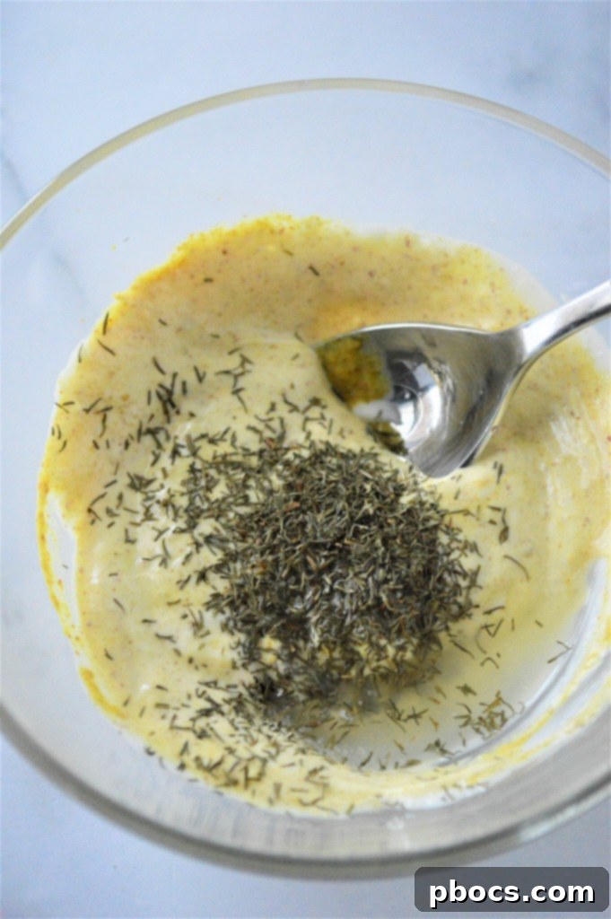 Step 2: Whisking together mayonnaise, dijon mustard, lemon juice, and dill in a separate bowl