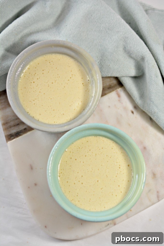 Effortless Keto Mug Cheesecake 11 Dividing cheesecake mixture into mugs