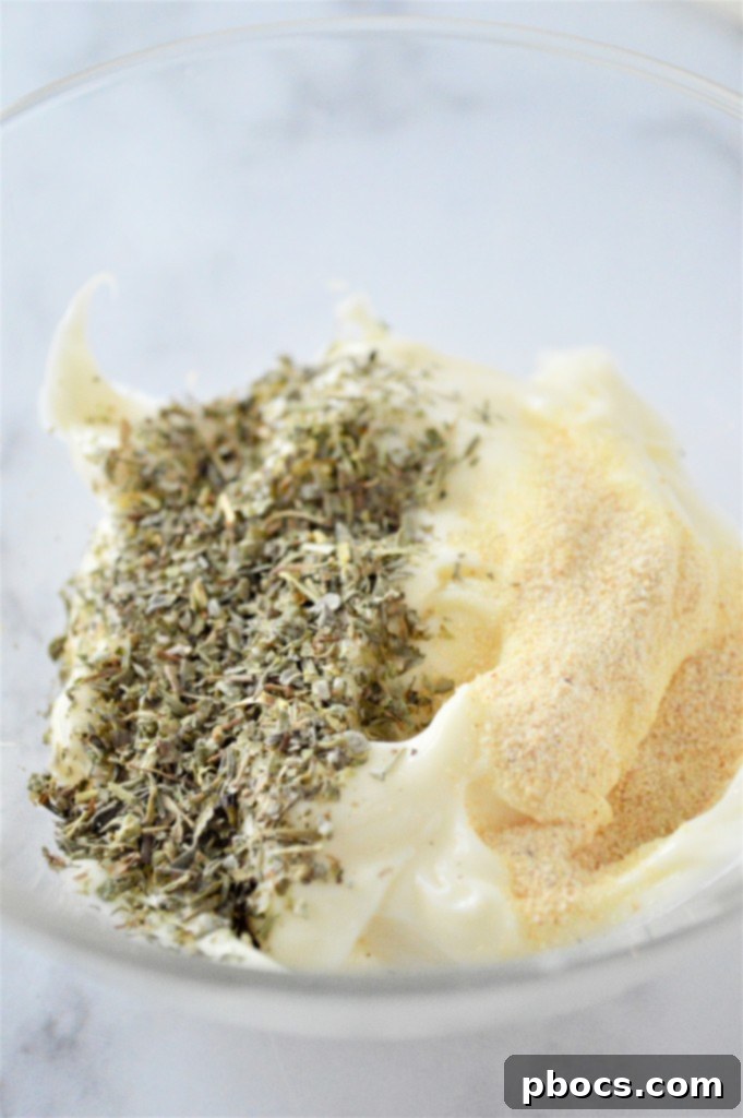 Keto Caprese Chicken Salad 9 Whisking mayo, garlic powder, and Italian seasoning