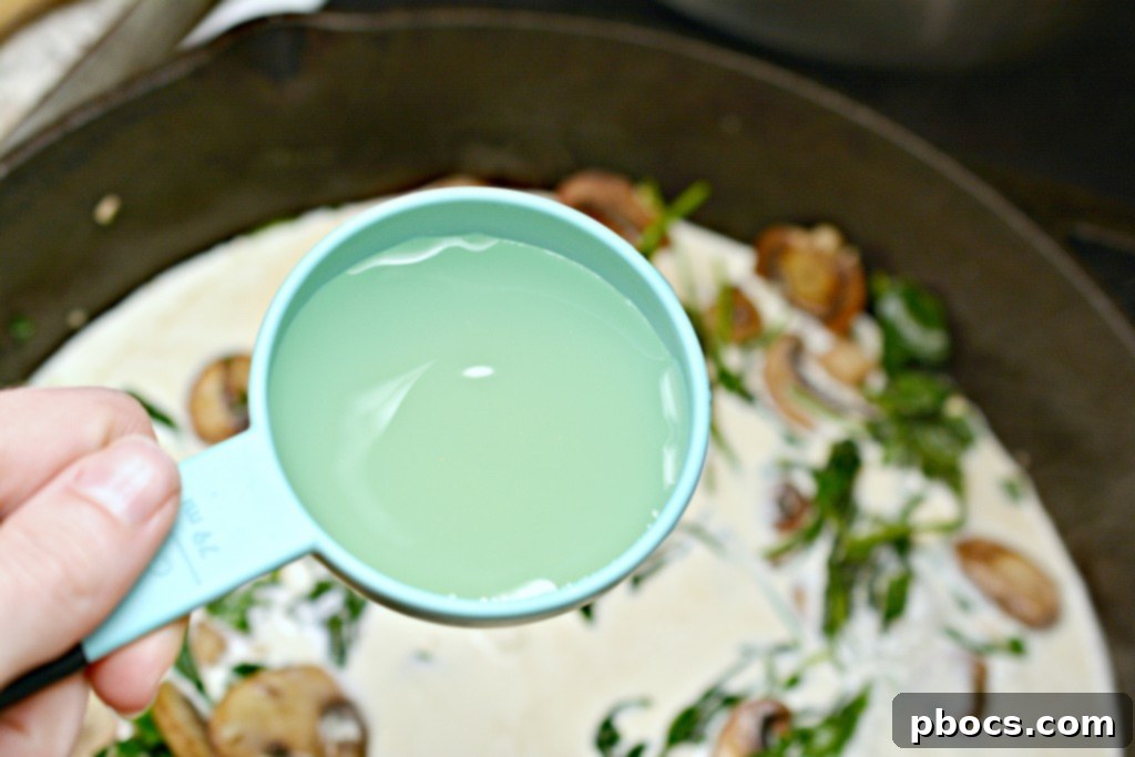 Flavor Packed Cajun Keto Chicken Meatballs 11 Spinach and garlic wilting in a skillet for the sauce