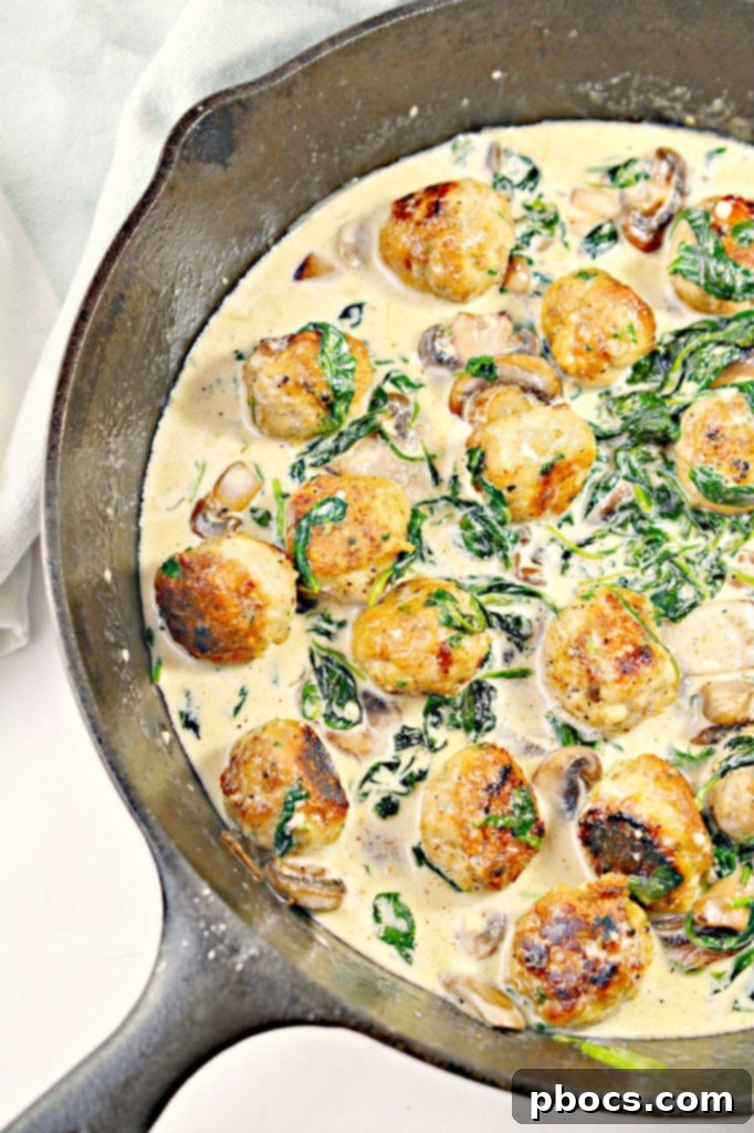 Flavor Packed Cajun Keto Chicken Meatballs 5 Close-up of the creamy Cajun sauce with mushrooms and spinach