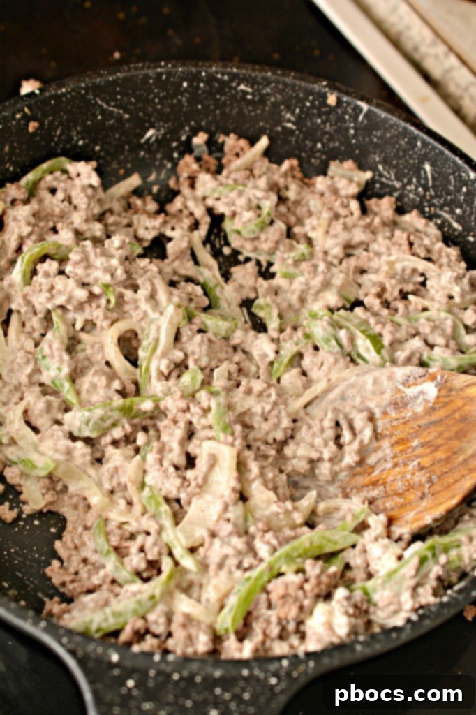 Baked cheese circles cooling on parchment paper after baking, ready for filling