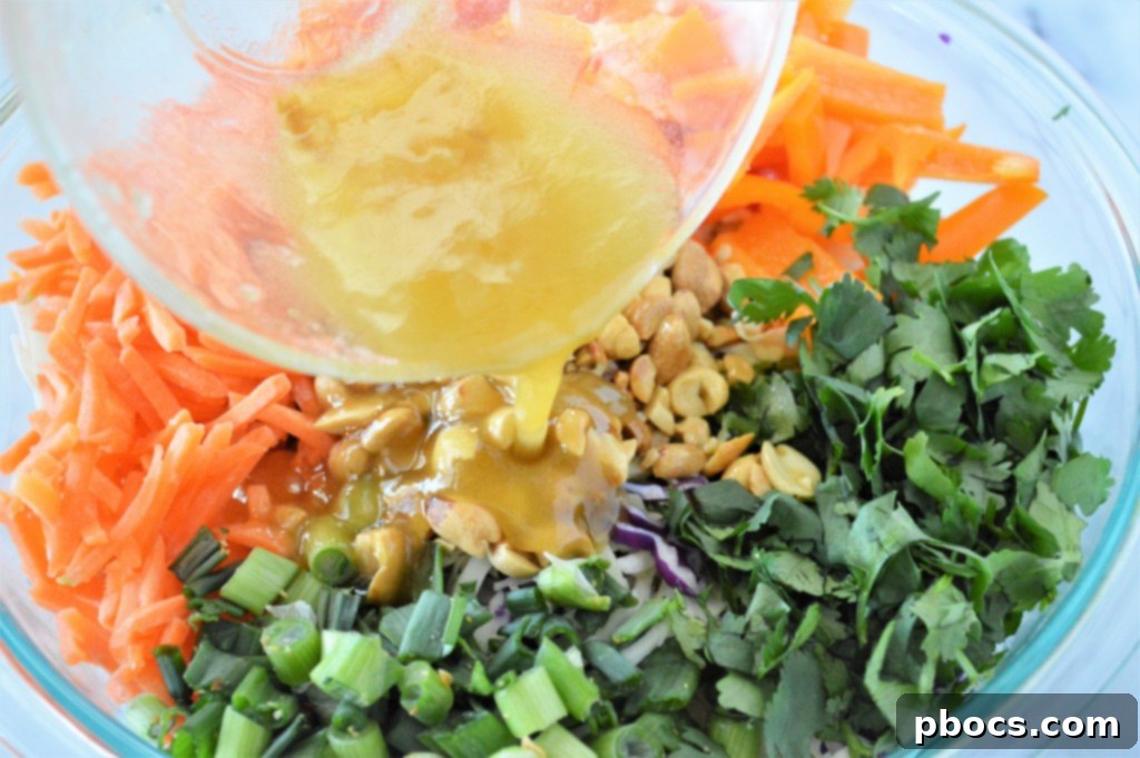 Zesty Keto Asian Slaw 13 Separate bowl with ingredients for the orange ginger vinaigrette being whisked