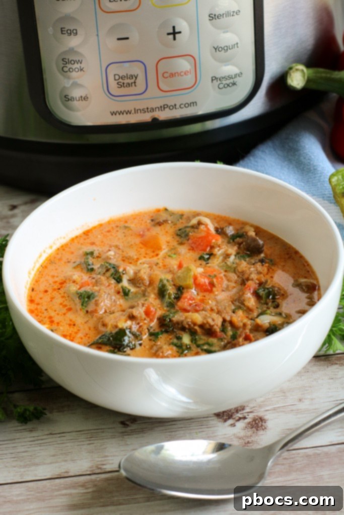 Serving Instant Pot Low Carb Pizza Soup with mozzarella and pepperoni