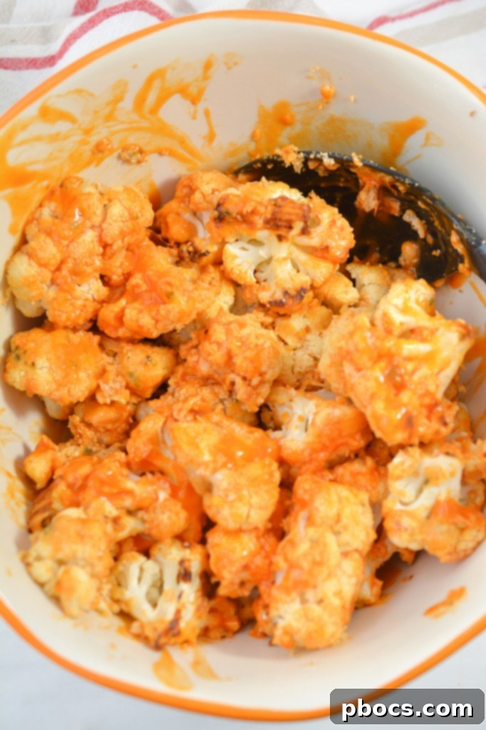 Golden Keto Cauliflower Bites 12 Coating cauliflower wings with hot sauce
