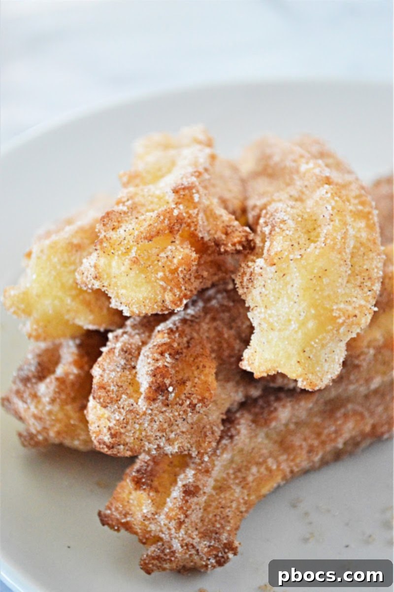Freshly fried keto churros draining on paper towels