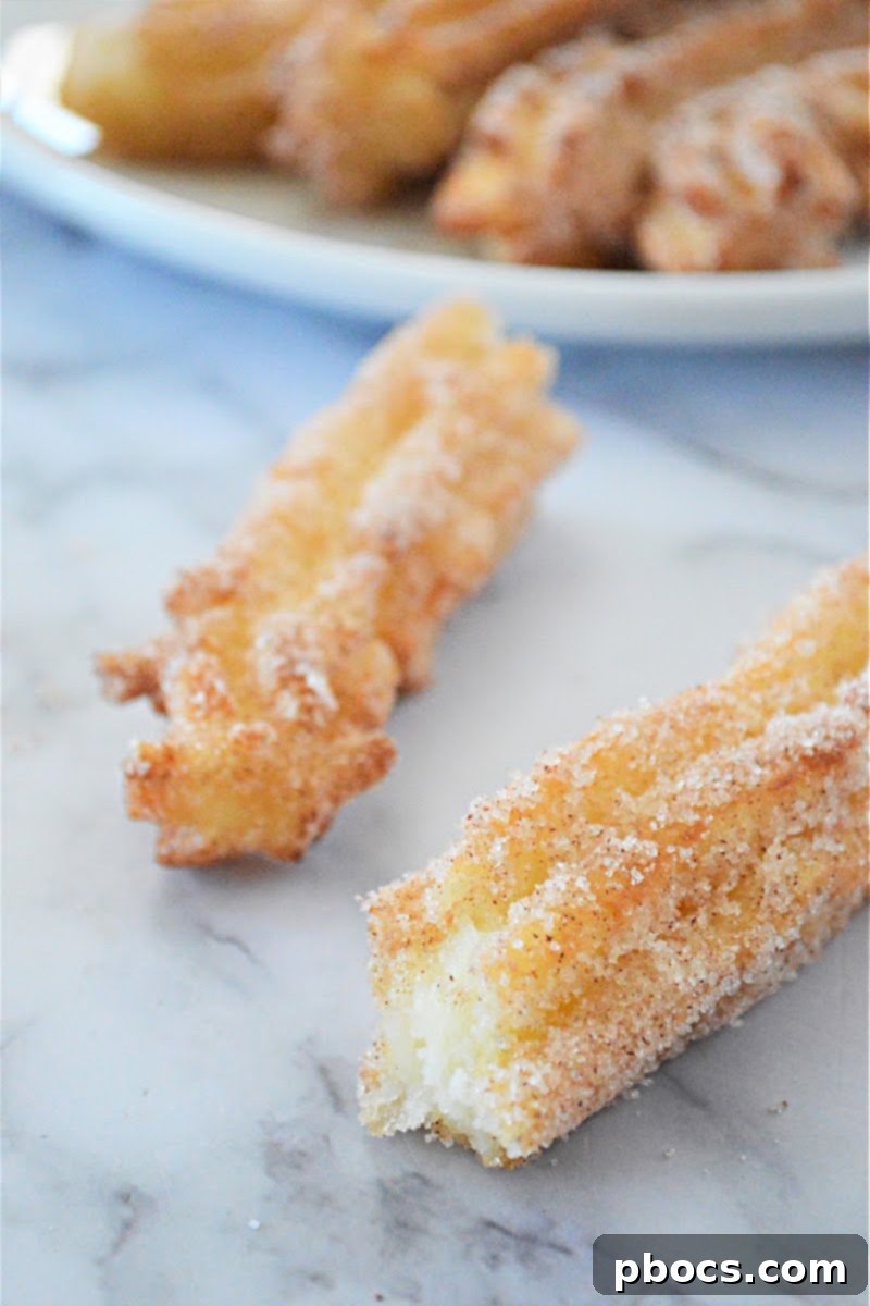 Closeup of keto churros being dusted with cinnamon sugar