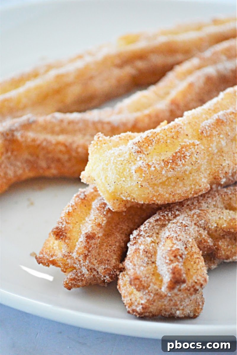 Stack of keto churros on a wooden board