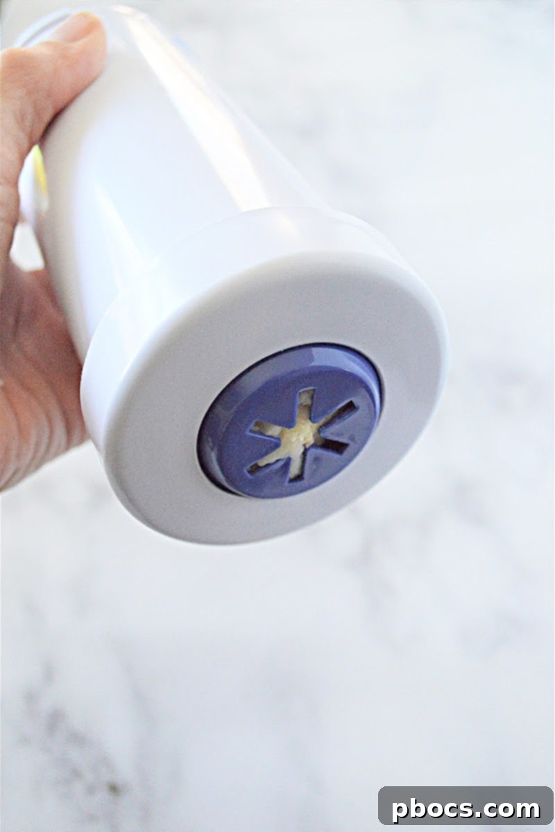 Piping churro dough onto a parchment paper