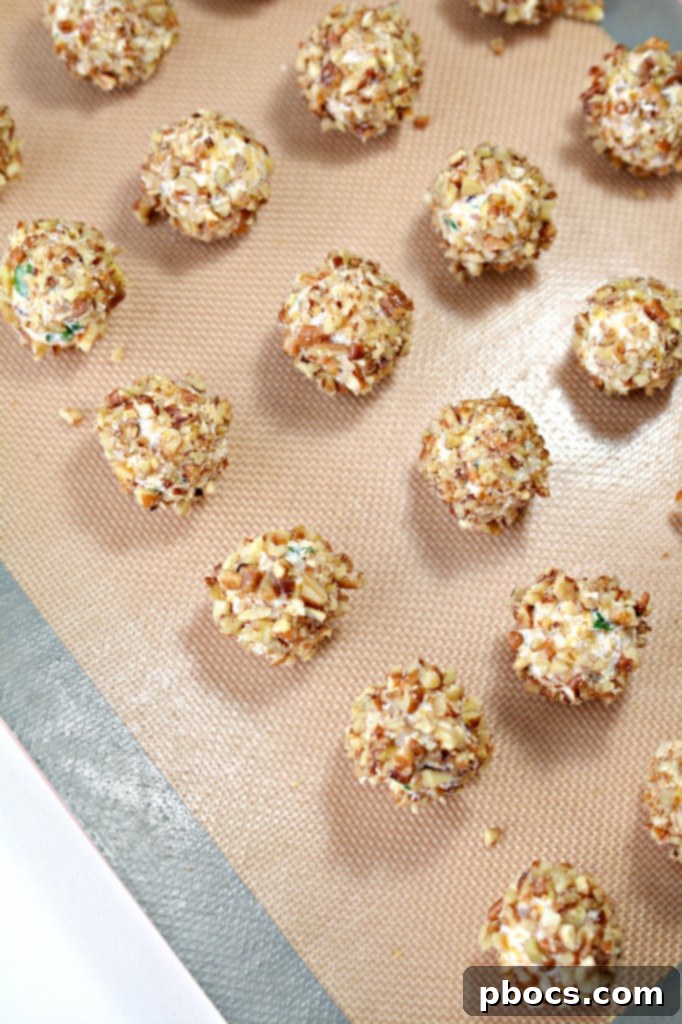 Finished mini keto cheese balls chilling on a tray