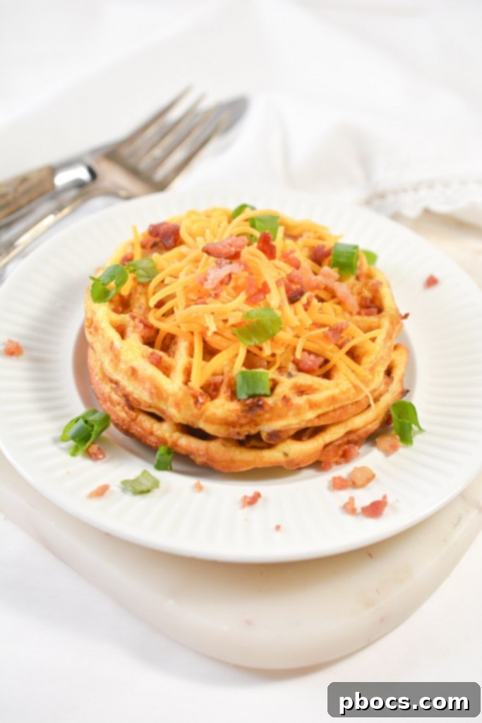 Ultimate Keto Chaffle Breakfast Sandwich 2 Delicious Keto Bacon Egg and Cheese Chaffles on a plate, ready to be enjoyed