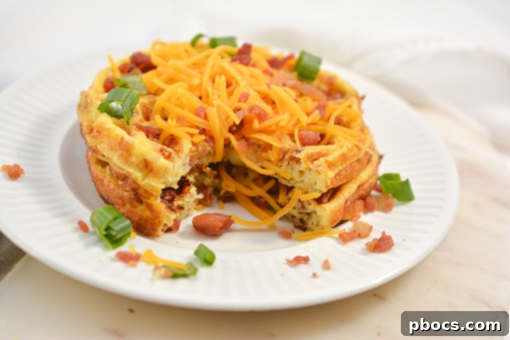 Ultimate Keto Chaffle Breakfast Sandwich 5 Freshly cooked Keto Bacon Egg and Cheese Chaffles stacked on a board