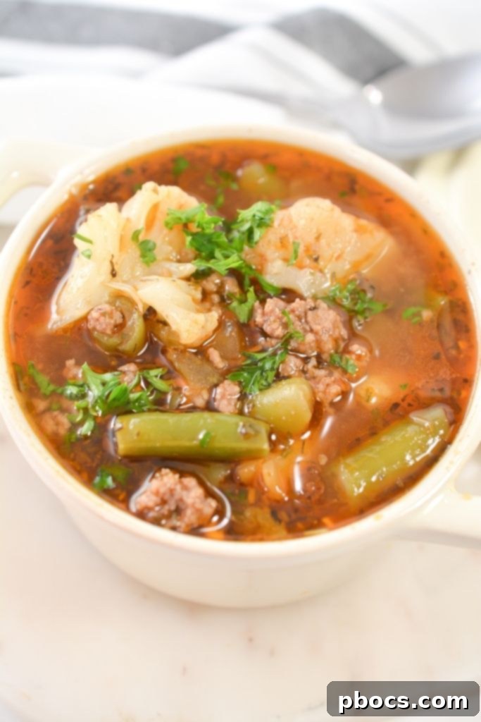 A Close-up of Low Carb Vegetable Beef Soup in a White Bowl