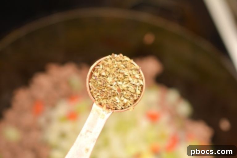 Adding Italian Seasoning to the Beef and Vegetable Mixture