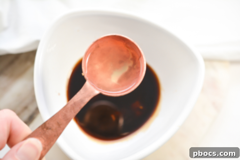 Chicken broth being added to a bowl