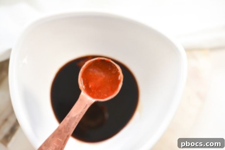 Chili Garlic sauce being added to a bowl