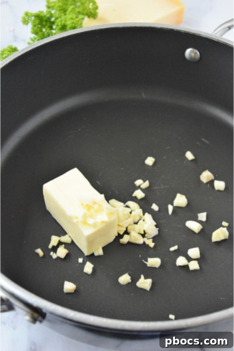 Melting butter with minced garlic in a skillet
