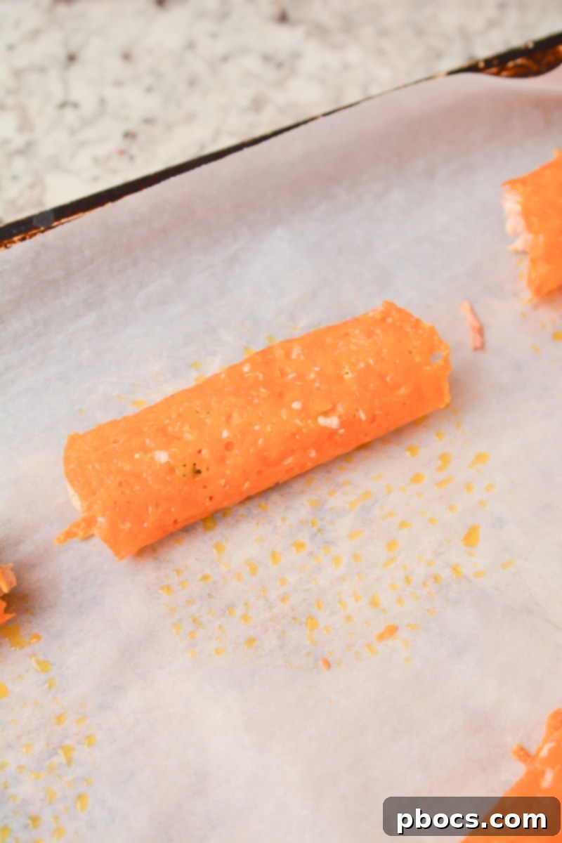 Cheesy Keto Chicken Enchilada Pinwheels 13 Folding cheese circles around chicken filling to create roll ups