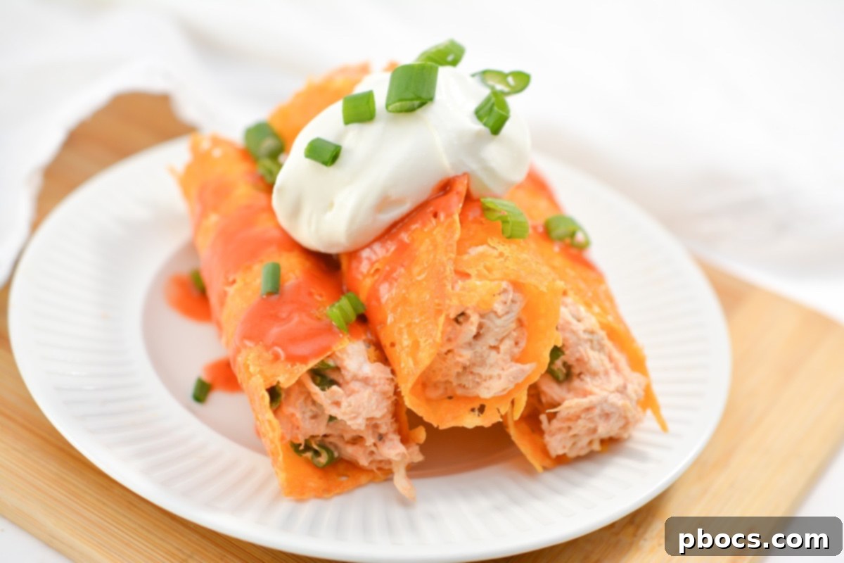 Cheesy Keto Chicken Enchilada Pinwheels 14 Serving keto chicken enchilada roll ups garnished with sour cream