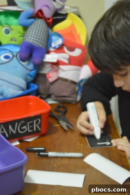 Craft Your Emotion Plush Storyboard 10 Applying chalkboard stickers and writing emotion names on bins