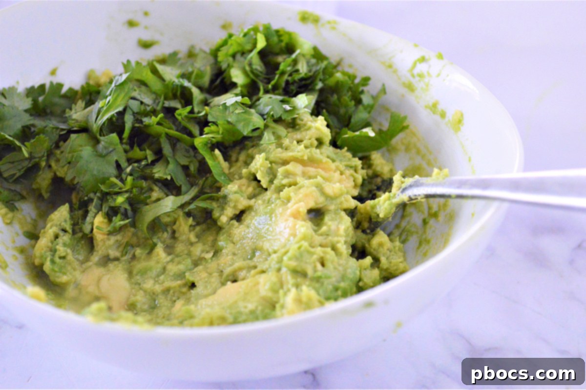 Zesty Cilantro Lime Cauliflower Rice with Creamy Avocado 12 Mashing avocados with lime and cilantro