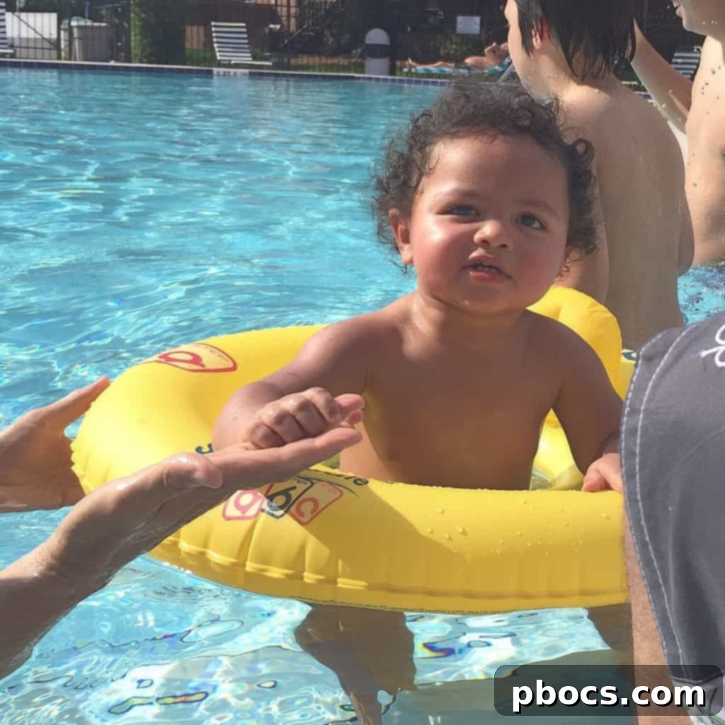 A group of happy children splashing and playing joyfully in a swimming pool on Fourth of July.