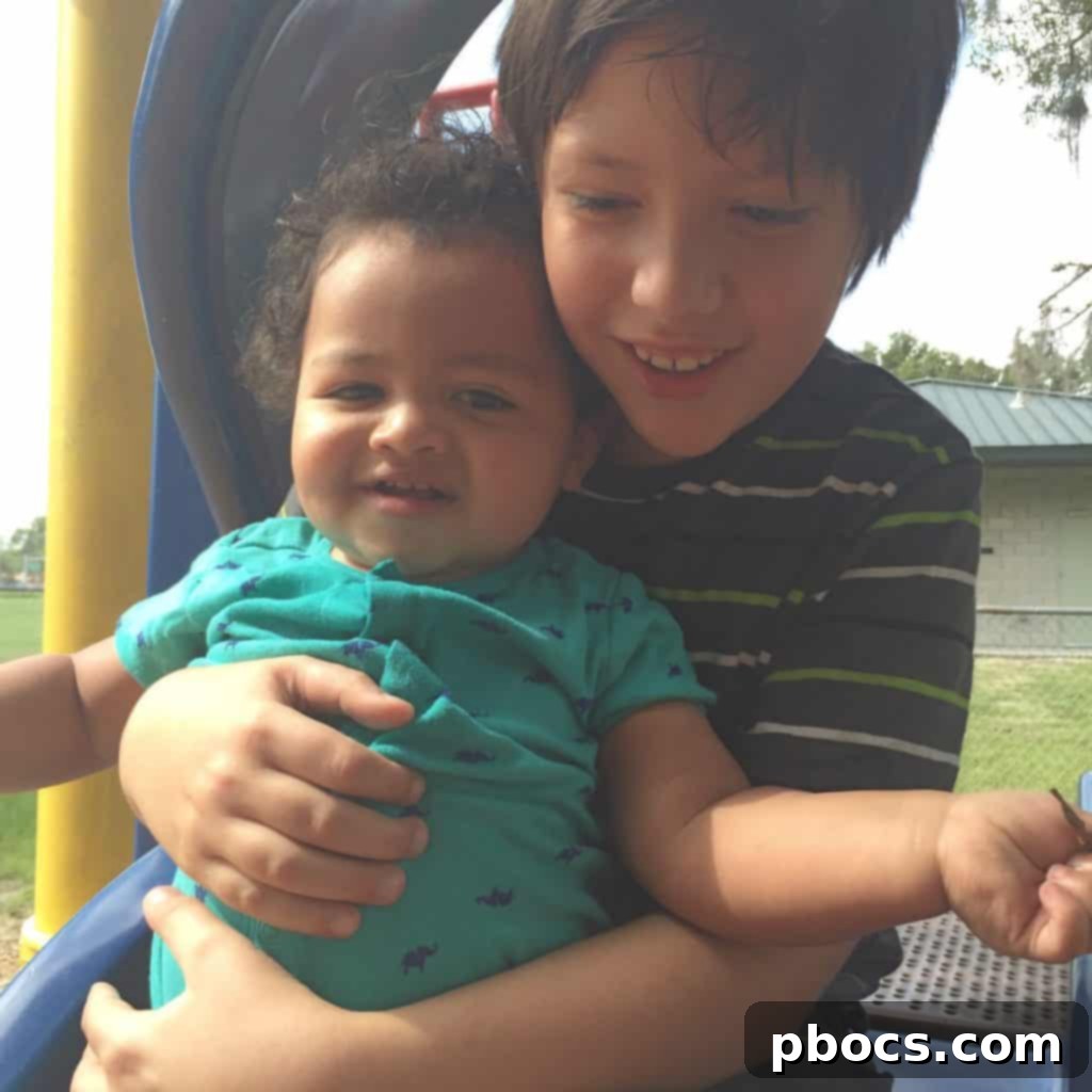 A candid shot of children playing together at the park on Fourth of July weekend, captured mid-action.